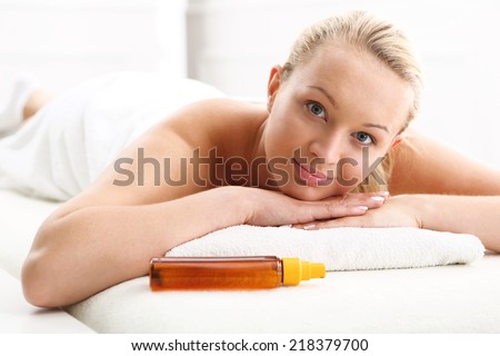Woman on the back massage. Attractive blonde woman in the office spa, relaxes August waiting for a cosmetic procedure.
