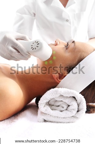 Sloping oval of the face  Ultrasound beauty treatment,The woman\'s face during a facial at a beauty salon