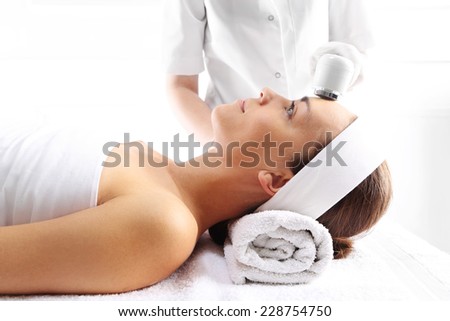 Facial treatment, ultrasound,The woman\'s face during a facial at a beauty salon
