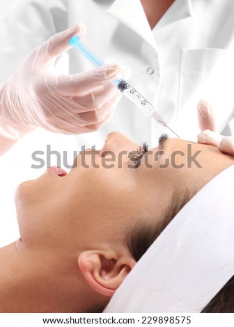 Fear of injections, scared woman. Portrait of a white woman during surgery filling facial wrinkles, Cosmetic is injected into facial skin cosmetics