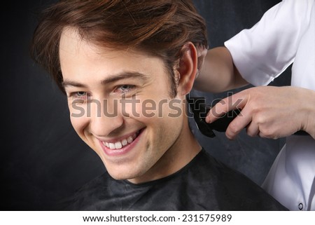 The guy at the hairdresser.Portrait of a young white boy while cutting hair in the hair salon