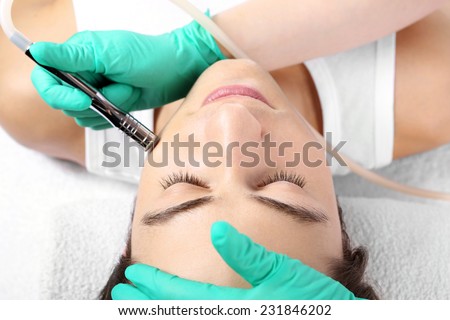 Removal of scars, man to a beautician, Microdermabrasion.Handsome man during microdermabrasion treatment in beauty salon