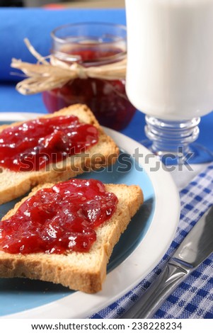 Toast with jam fruit  Homemade breakfast, toast with jam, a glass of milk and a jar of jam