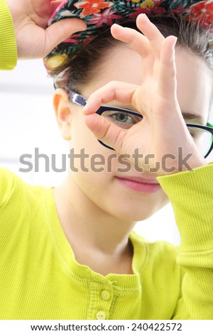The little shrew, a girl in colorful clothes. Portrait of girl in colorful clothes and cap doing funny faces