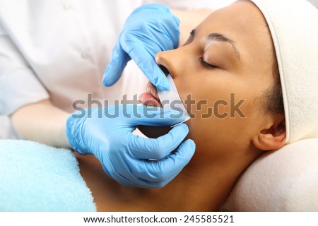 Depilation with hot wax mustache in the beauty salon