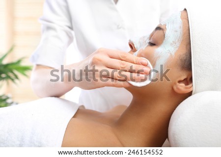 Cleansing facial skin, a woman in beauty salon . Beautiful woman during treatments in the spa salon