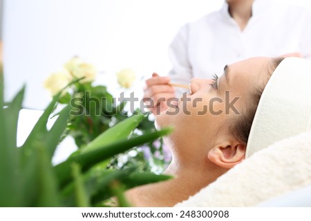 Relaxed woman at the beautician.The woman\'s face during a facial at a beauty salon