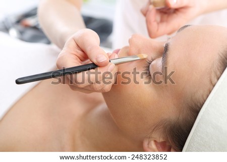 Make up artist, makeup professional in the beauty salon. Woman in a beauty salon, makeup artist applied primer for face