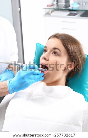Dentist. Woman at the dentist\'s chair during a dental procedure