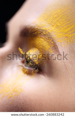 Loose eyeshadow, close-up on a woman eye. Portrait, close-up on the face of a woman in a fancy makeup.