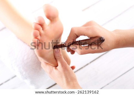 Foot massage, Foot reflexology.Natural medicine, reflexology, acupressure foot massage oppresses energy flow points
