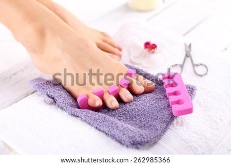Home pedicure. Foot care treatment and nail, the woman at the beautician for pedicure.