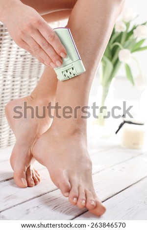 Hair removal, feminine smooth legs. Female calves depilated electric depilator