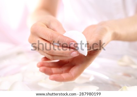Manicure, washing nail polish. Manicurist remove nail polish remover and a cotton pad