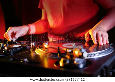 DJ beats with black plate. Hands DJ mixing music at the club during the event