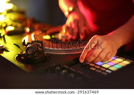 DJ. Hands DJ mixing music at the club during the event