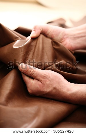 The plant leather craftsman.\
Hands tailor to check the quality of the material