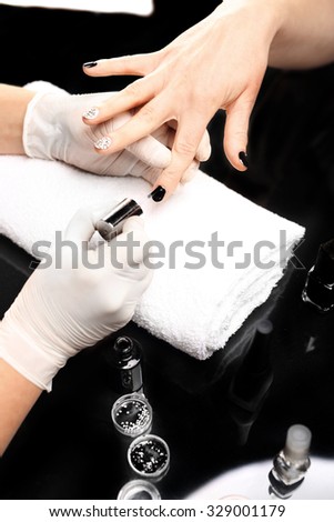 Manicure designs on nails. Beauty salon, manicure, woman to a beautician for manicure