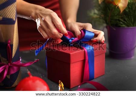 Gift wrapping. Woman packs gifts, step by step