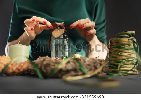 Christmas house decoration. Christmas. Woman packs a Christmas gift and decorating the house with Christmas decorations
