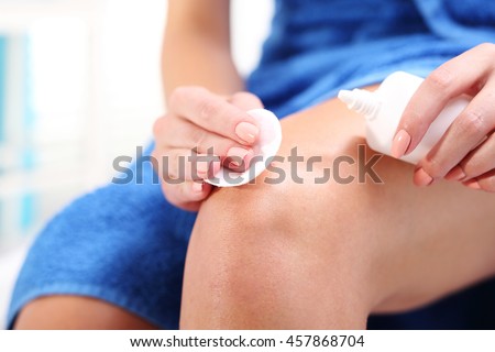 Disinfection of wounds with hydrogen peroxide. Female disinfects the wound on his knee pouring with oxygenated water.