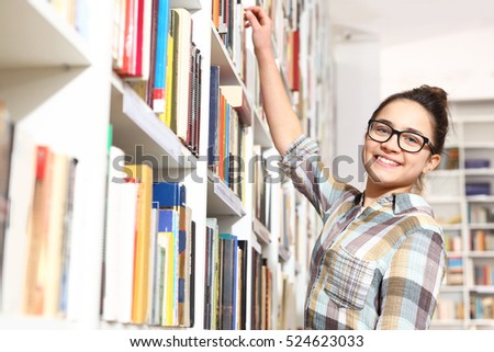 Library, teenager  chooses a book