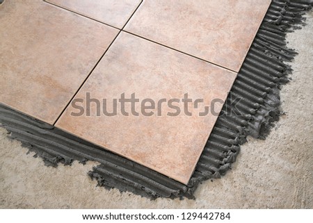 laying floor tiles