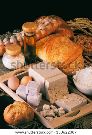 Still life with bread and products for making bread on a black background