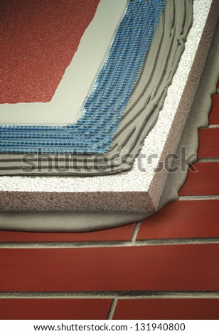 insulated brick wall with plaster, glue, net, polystyrene, thermal protection