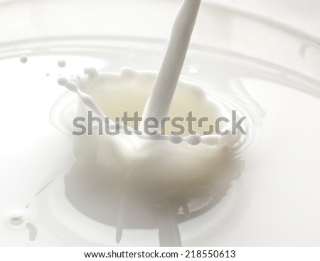 stream of milk is poured into a container