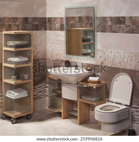 detail of a modern bathroom with sink, cabinet for towels and toilet