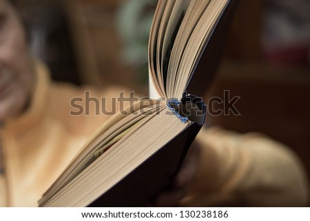 open book in the hands of  elderly women