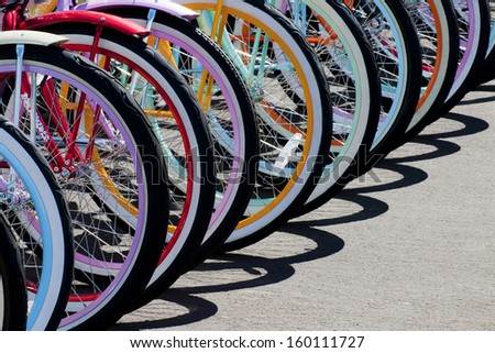 Colorful bike wheel parked to make a pattern