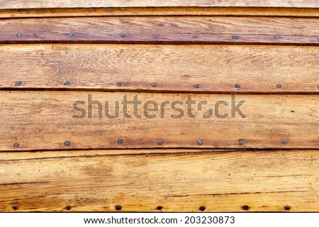 Side of a golden pine wooden boat that\'s ship lap
