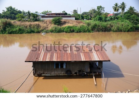 old houseboat in the red river galvanized iron roof