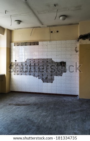 Falling off tiles on a wall in an abandoned hospital