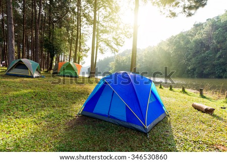 tourist tent in forest camp with sun rise