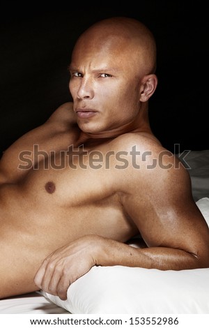 Portrait of handsome bodybuilder, bold headed man looking at camera.