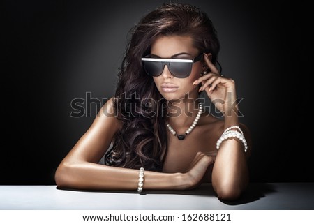Young Beautiful Brunette Woman Posing Wearing Sunglasses And Jewelry.