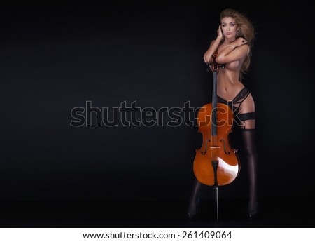 Sexy beautiful naked woman posing with cello.