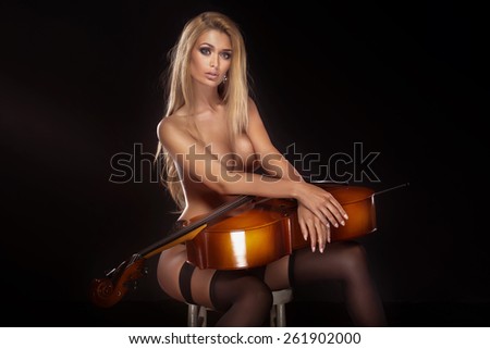 Sexy beautiful naked woman posing with cello.