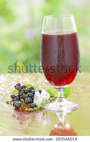 Fresh Black currant juice on wooden table