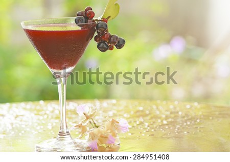 Fresh Black currant juice on wooden table