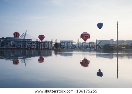 PUTRAJAYA, MALAYSIA - MARCH 30:Multi shaped hot air balloons floating over sunrise skies at the 5th Putrajaya International Hot Air Balloon Fiesta in Putrajaya, Malaysia on March 30, 2013