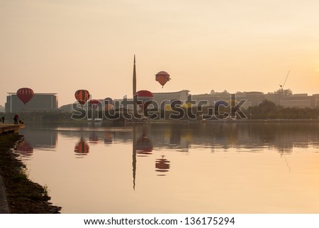 PUTRAJAYA, MALAYSIA - MARCH 30:Colourful hot air balloons floating over sunrise skies at the 5th Putrajaya International Hot Air Balloon Fiesta in Putrajaya, Malaysia on March 30, 2013