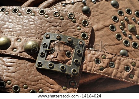 close-up of leather goods with buckle and studs