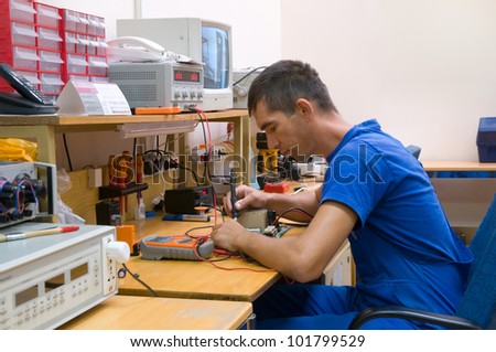 The electrician is engaged in repair of an electric equipment