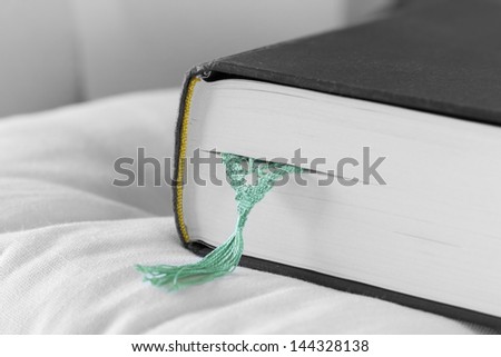 Black book with green ribbon on white background