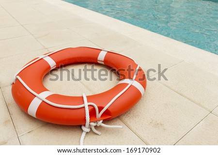 Orange lifeguard in swimming pool