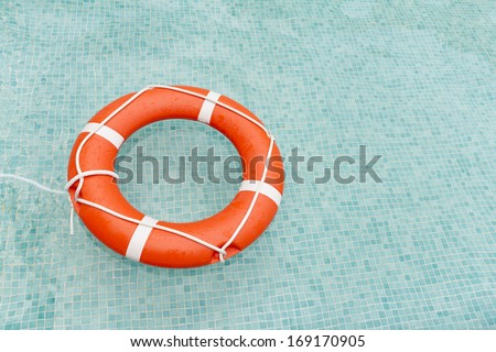 Orange lifeguard floating in swimming pool
